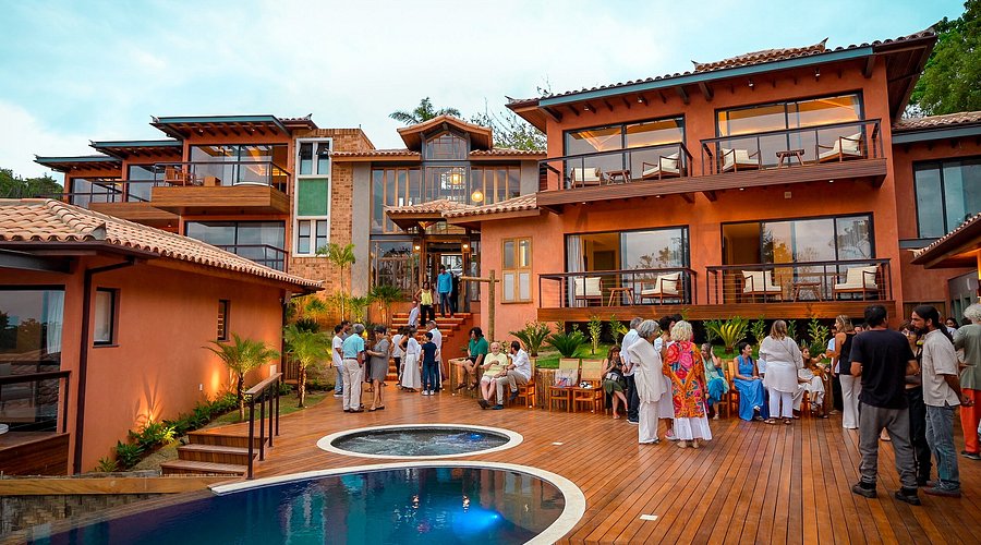 Hotel Buzios Espiritualidade al atardecer, deck y piscina con huespedes